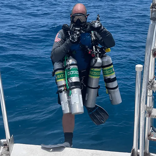 A technical diver rigged for a CCR dive on Roatán's wall